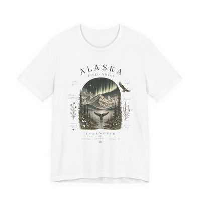 Graphic t-shirt with a vintage Alaska aurora scene of glowing peaks, a whale tail and soaring eagle by Evernorth — on model