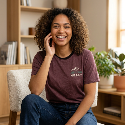 Soft jersey t-shirt with a detailed Healy Alaska mountain and spruce illustration in earthy tones by Evernorth — front view
