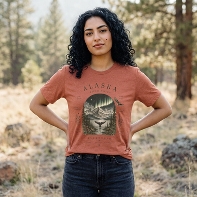 Graphic t-shirt with a vintage Alaska aurora scene of glowing peaks, a whale tail and soaring eagle by Evernorth — front view