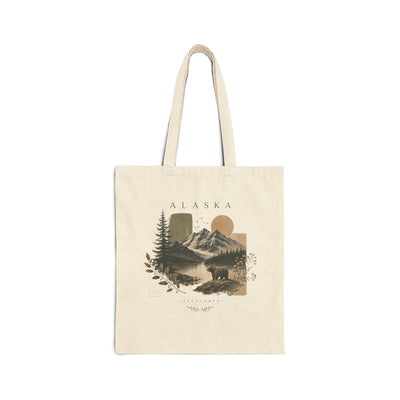Natural cotton canvas tote bag printed with a layered Alaska mountain and pine forest scene by Evernorth — front view