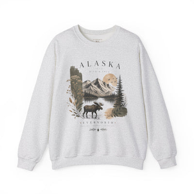 Soft crewneck sweatshirt with a muted Alaska mountain, lake, evergreen and moose illustration by Evernorth — back view